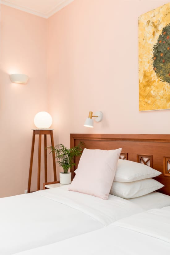 a bed with a painting on the wall