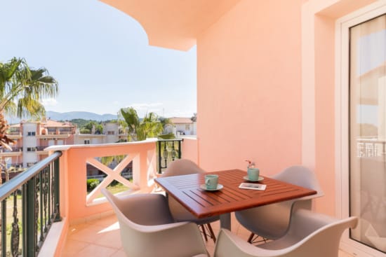 a table and chairs on a balcony