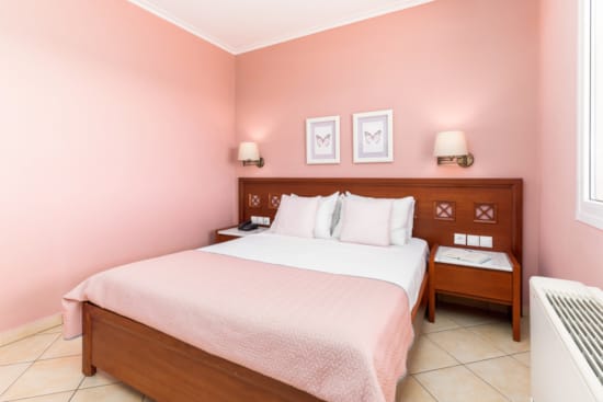 a bedroom with a bed and a bench