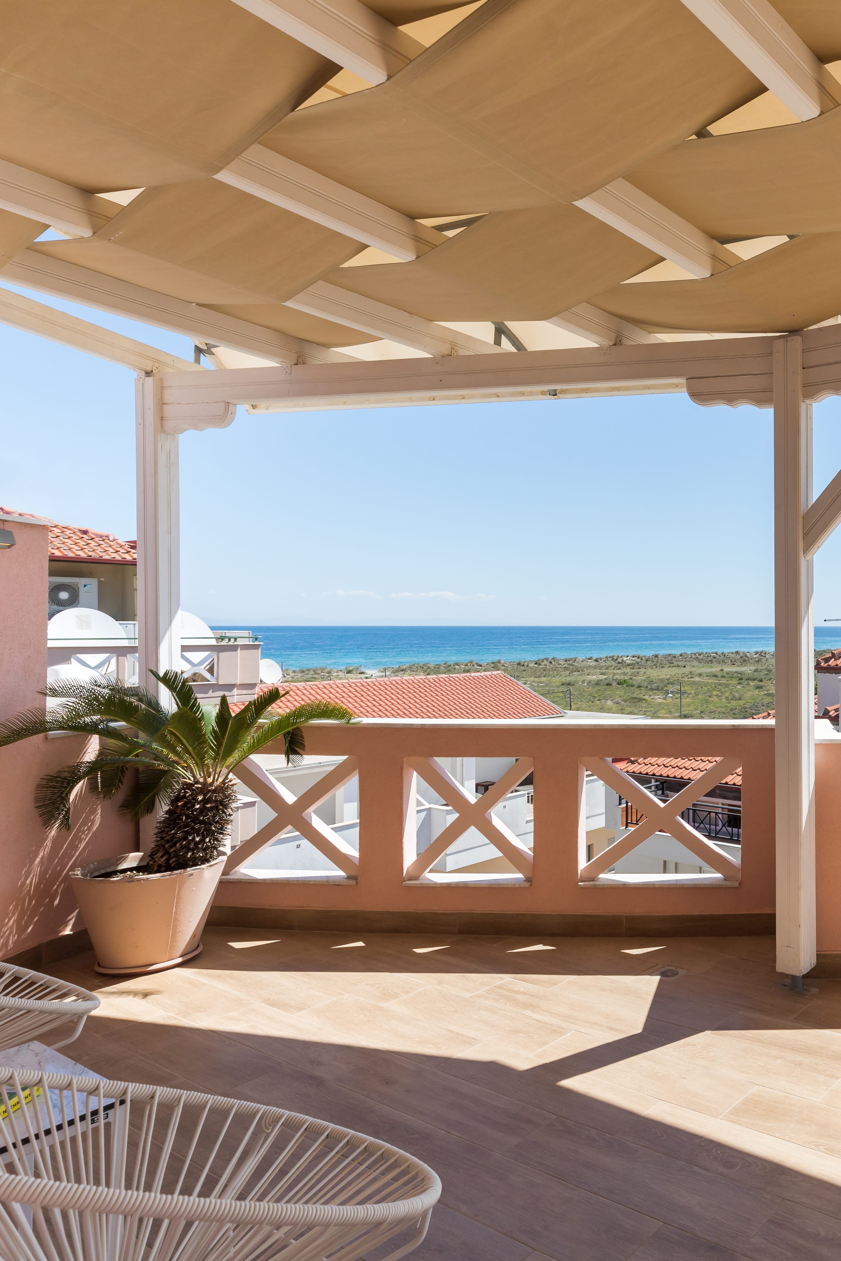 a deck with a view of the ocean and a beach
