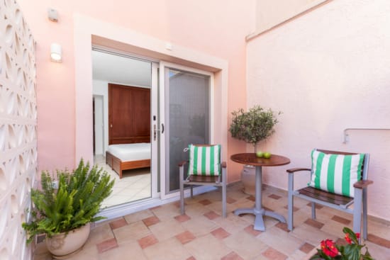 a room with a table chairs and a door