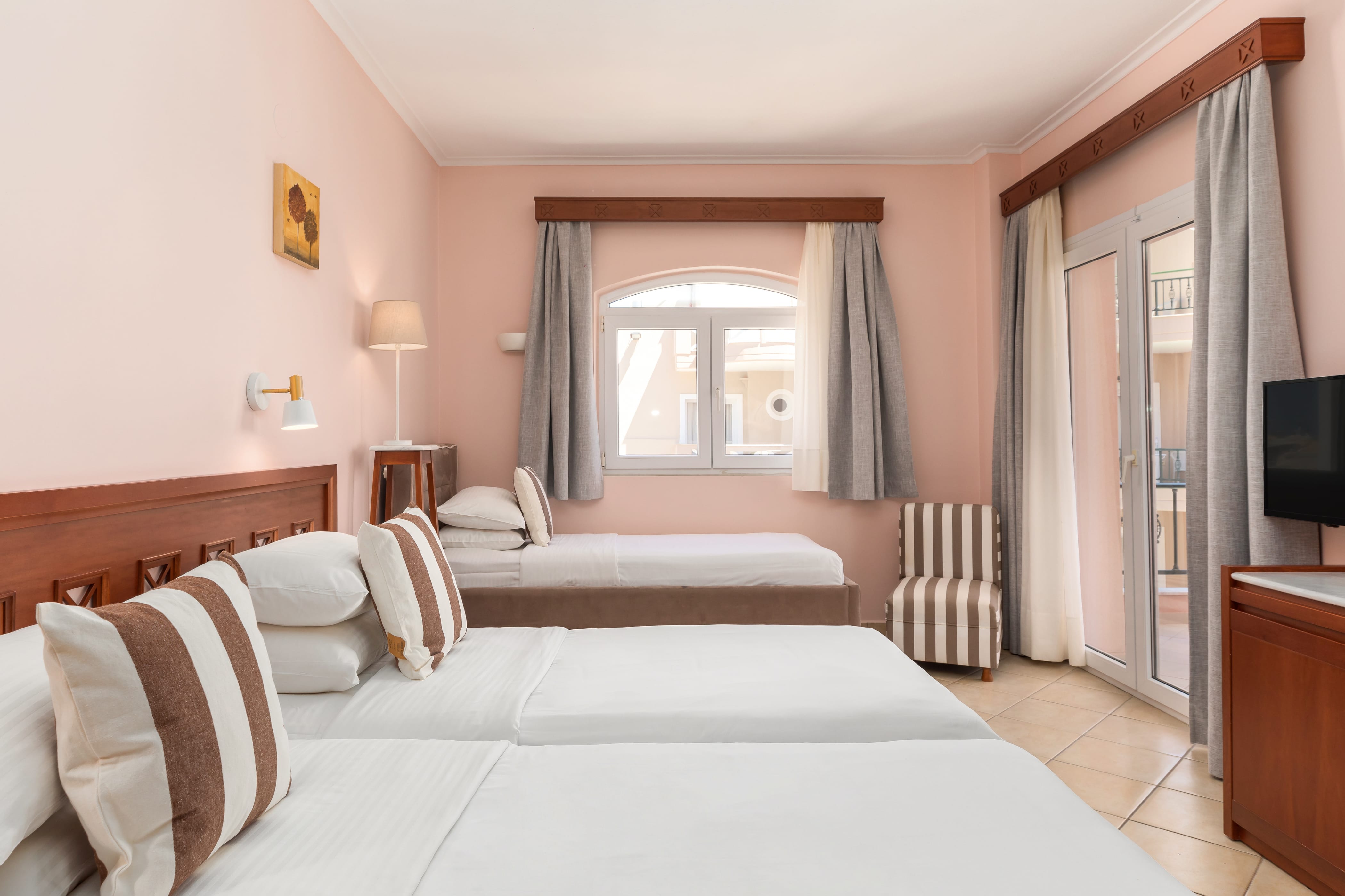 a bedroom with a bed and a tv