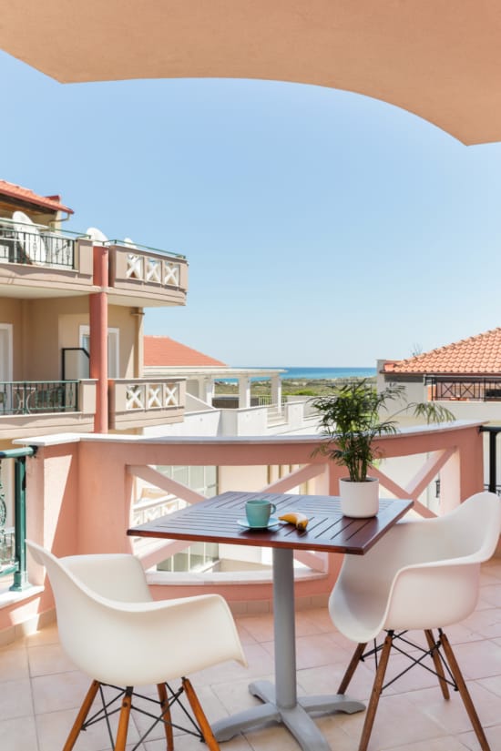 a table and chairs on a balcony