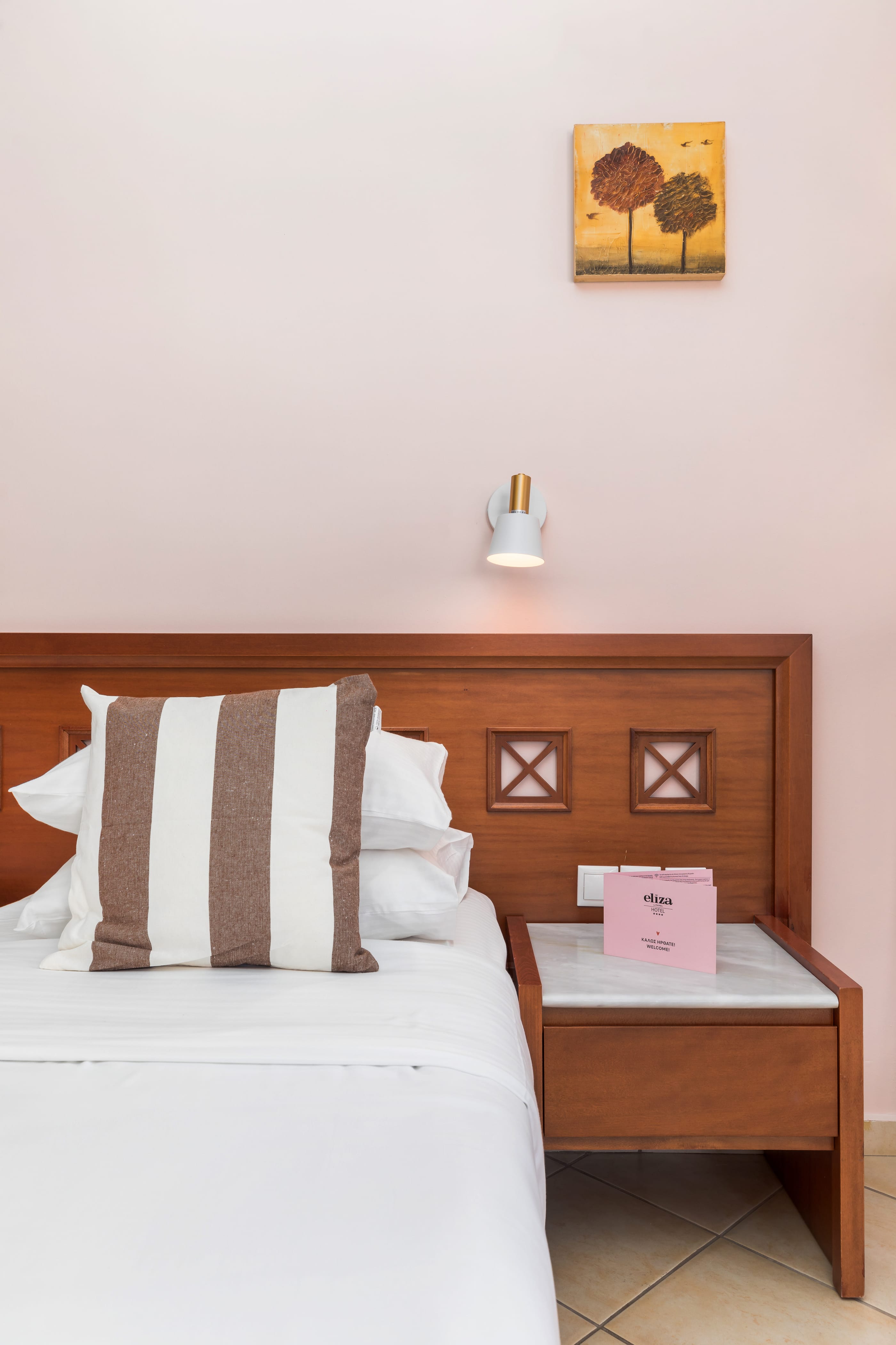 a bed with a pillow and a lamp on it