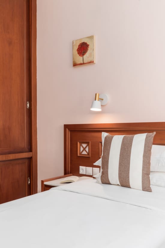 a bed with a pillow and a lamp on it