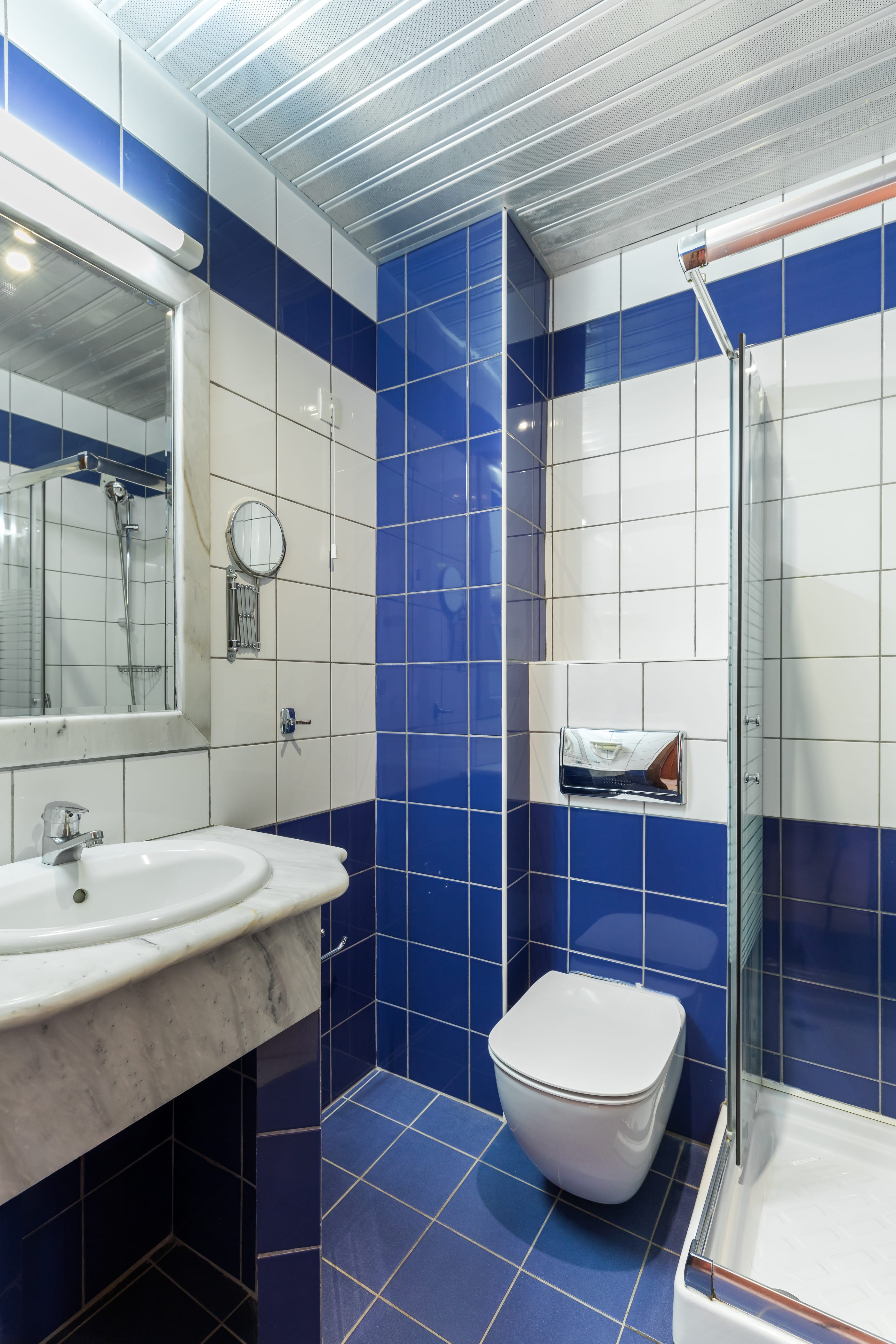 a bathroom with blue tiles