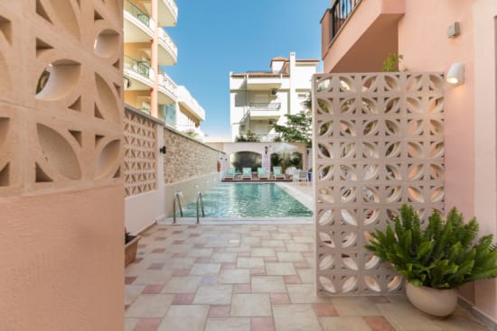a pool in a courtyard between buildings
