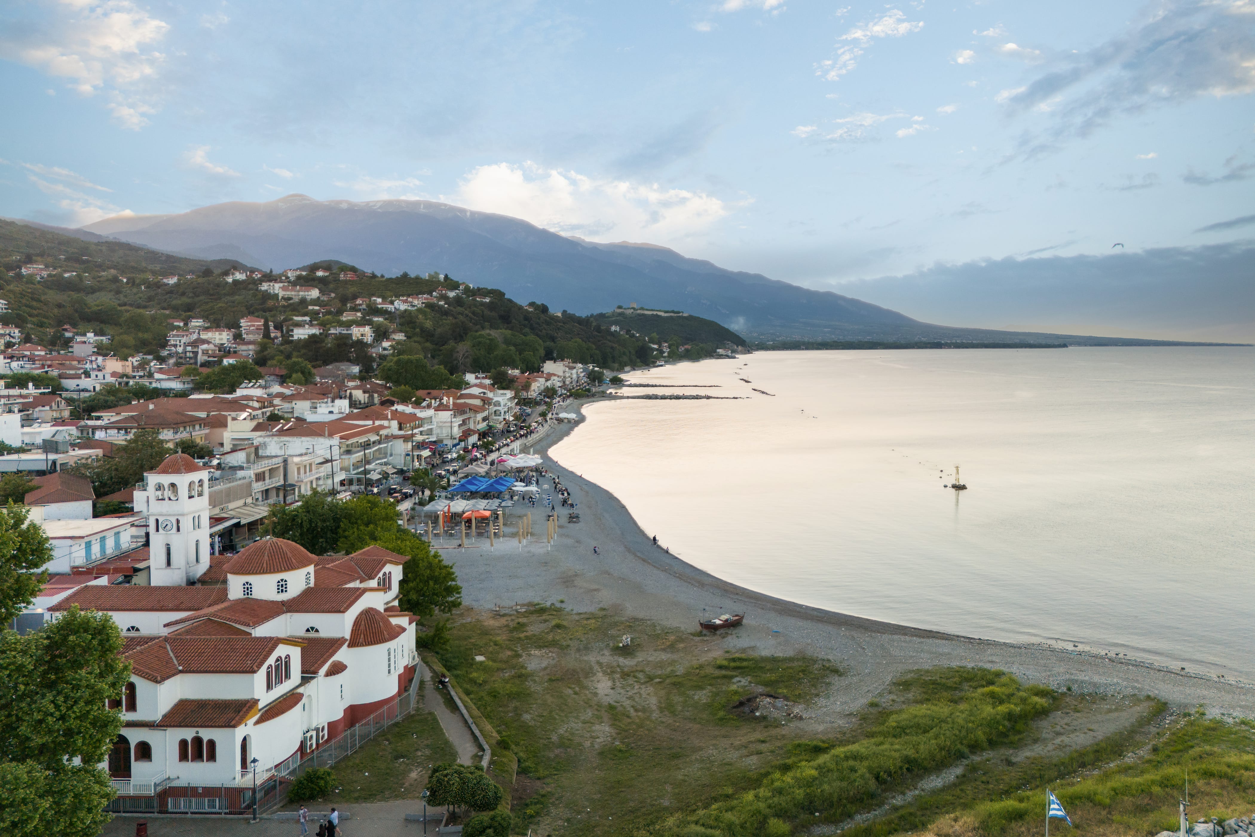 a beach with buildings and trees