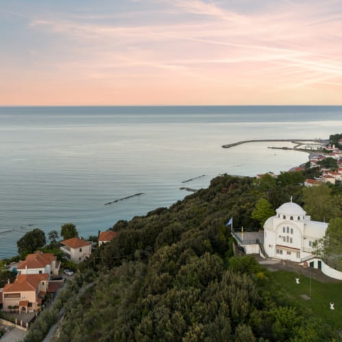 a town on a hill by the water