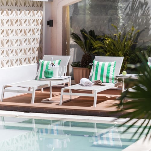 a pool with a table and chairs