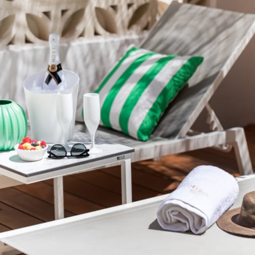 a table with a white chair and a white table with a white cloth and a white table with