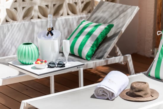 a table with a white chair and a white table with a white cloth and a white table with