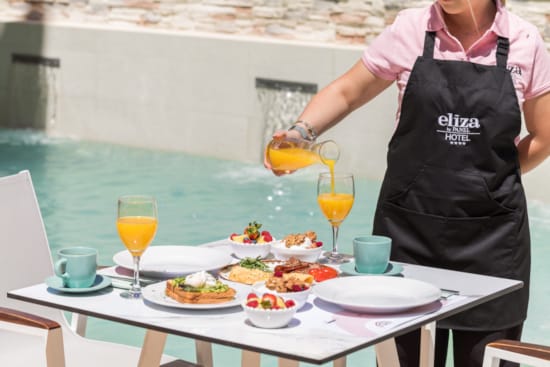 a person pouring a drink into a glass