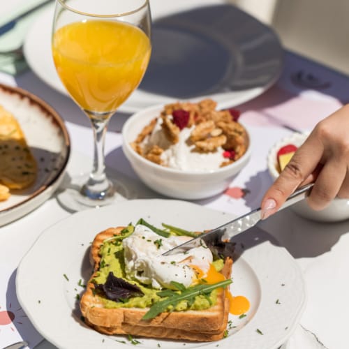 a person cutting a sandwich