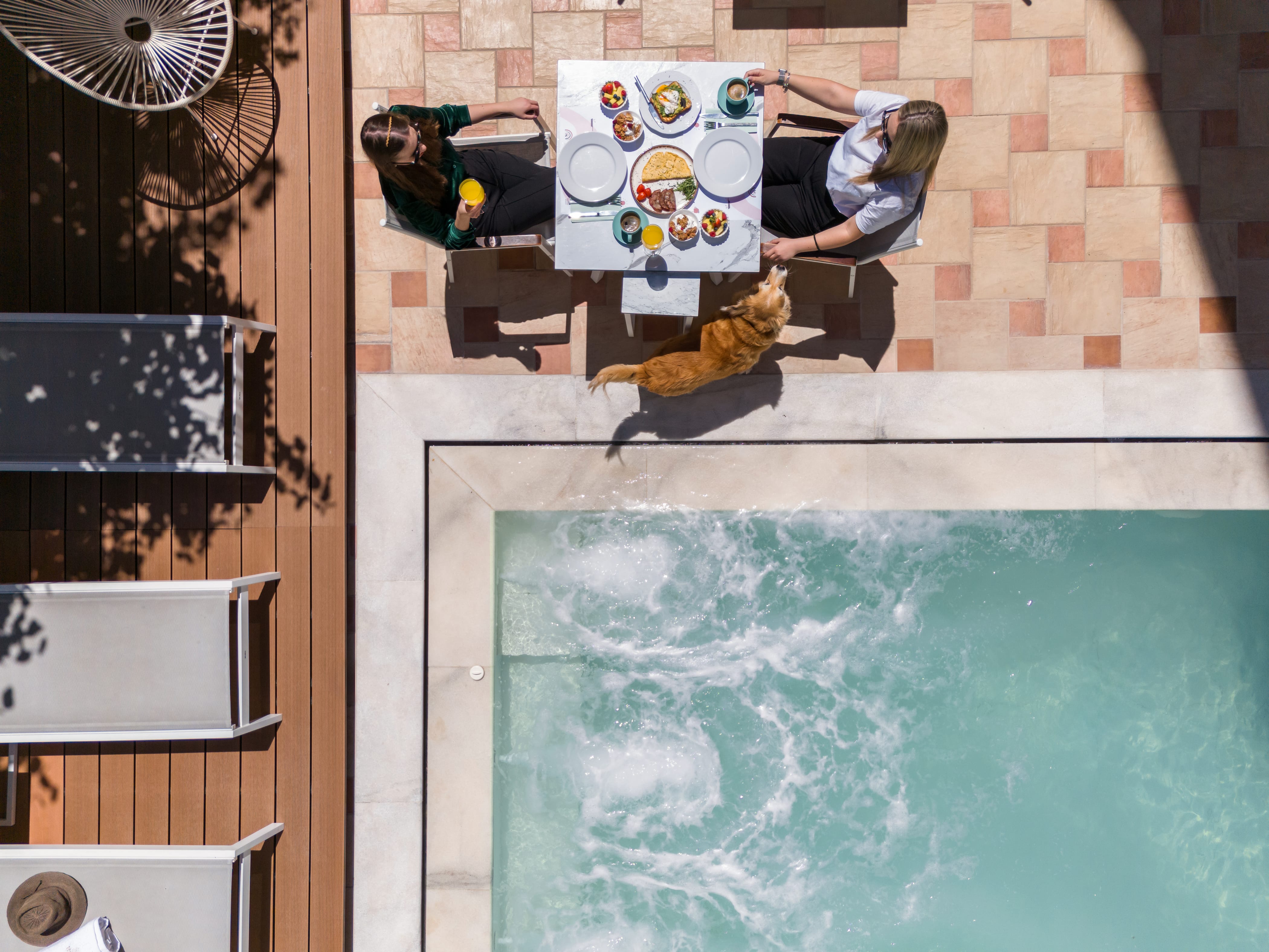 a group of people sitting around a pool