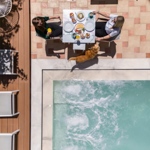 a group of people sitting around a pool