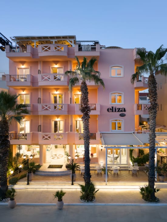 a building with palm trees in front of it