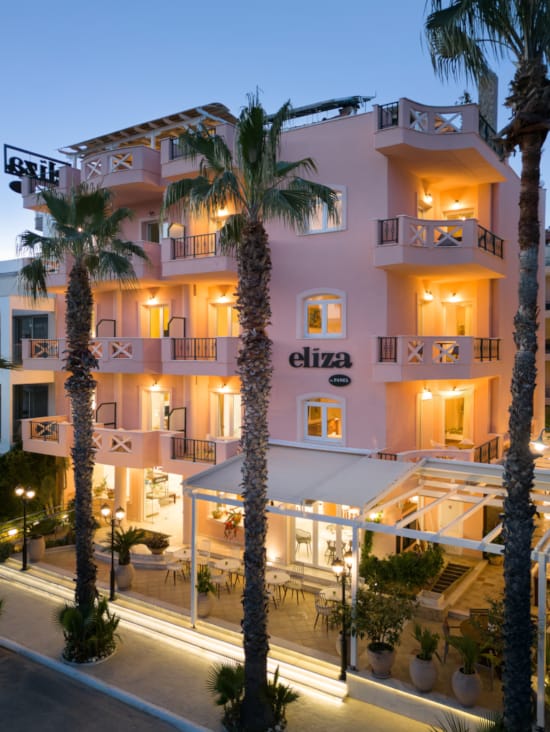 a building with palm trees in front