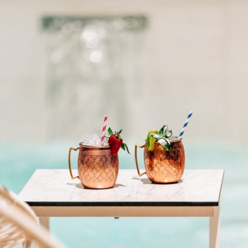 two brown pots with plants in them
