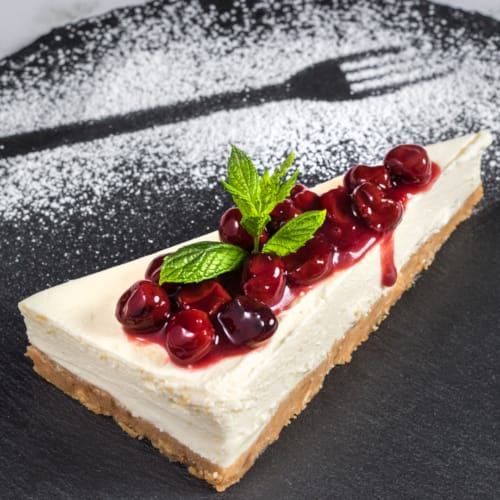 a piece of cake with fruit on top