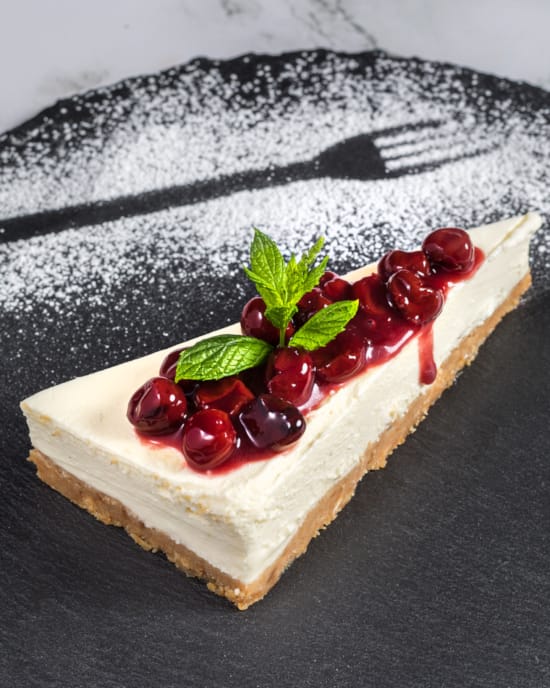 a piece of cake with fruit on top