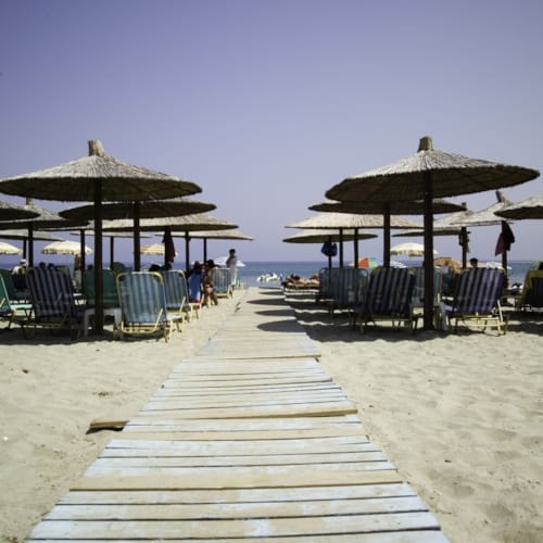 a boardwalk with umbrellas and chairs