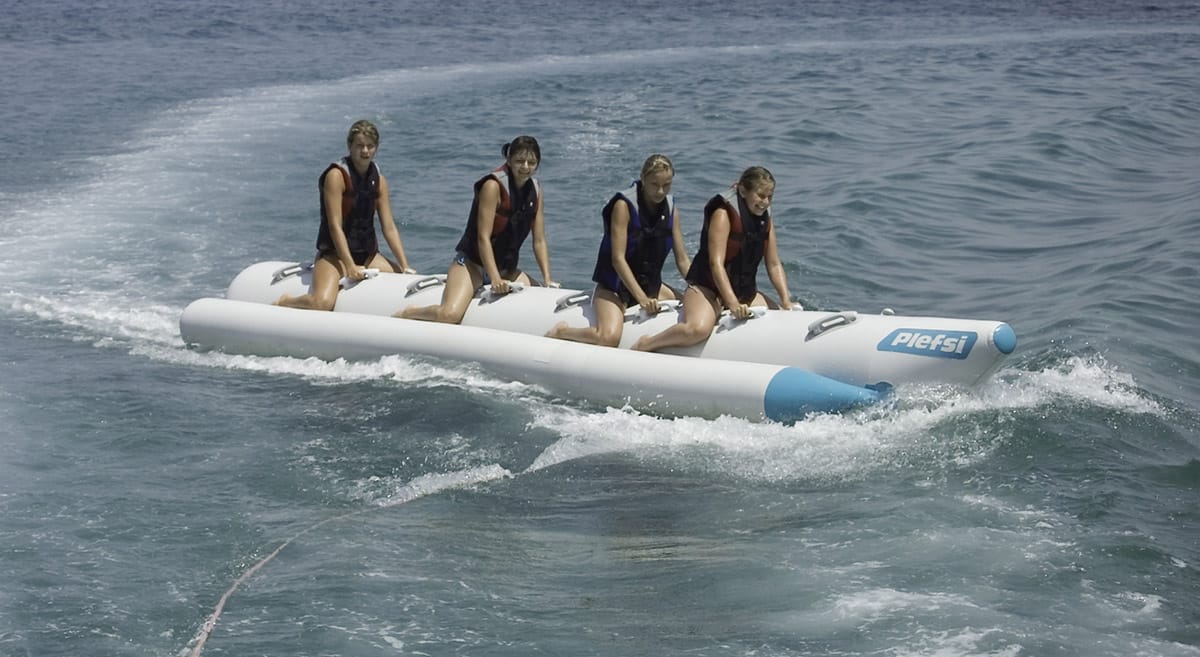 a group of women on a jet ski in the water