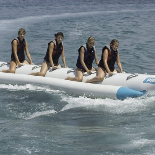 a group of women on a jet ski in the water