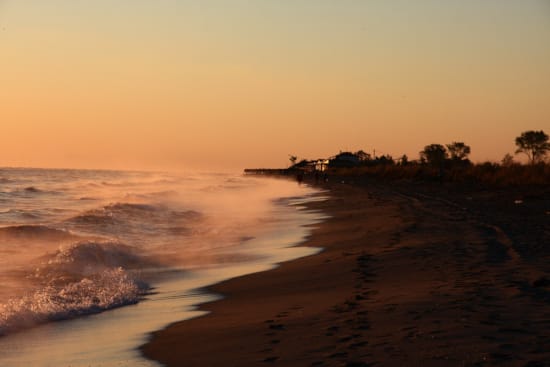 a beach with waves crashing on it