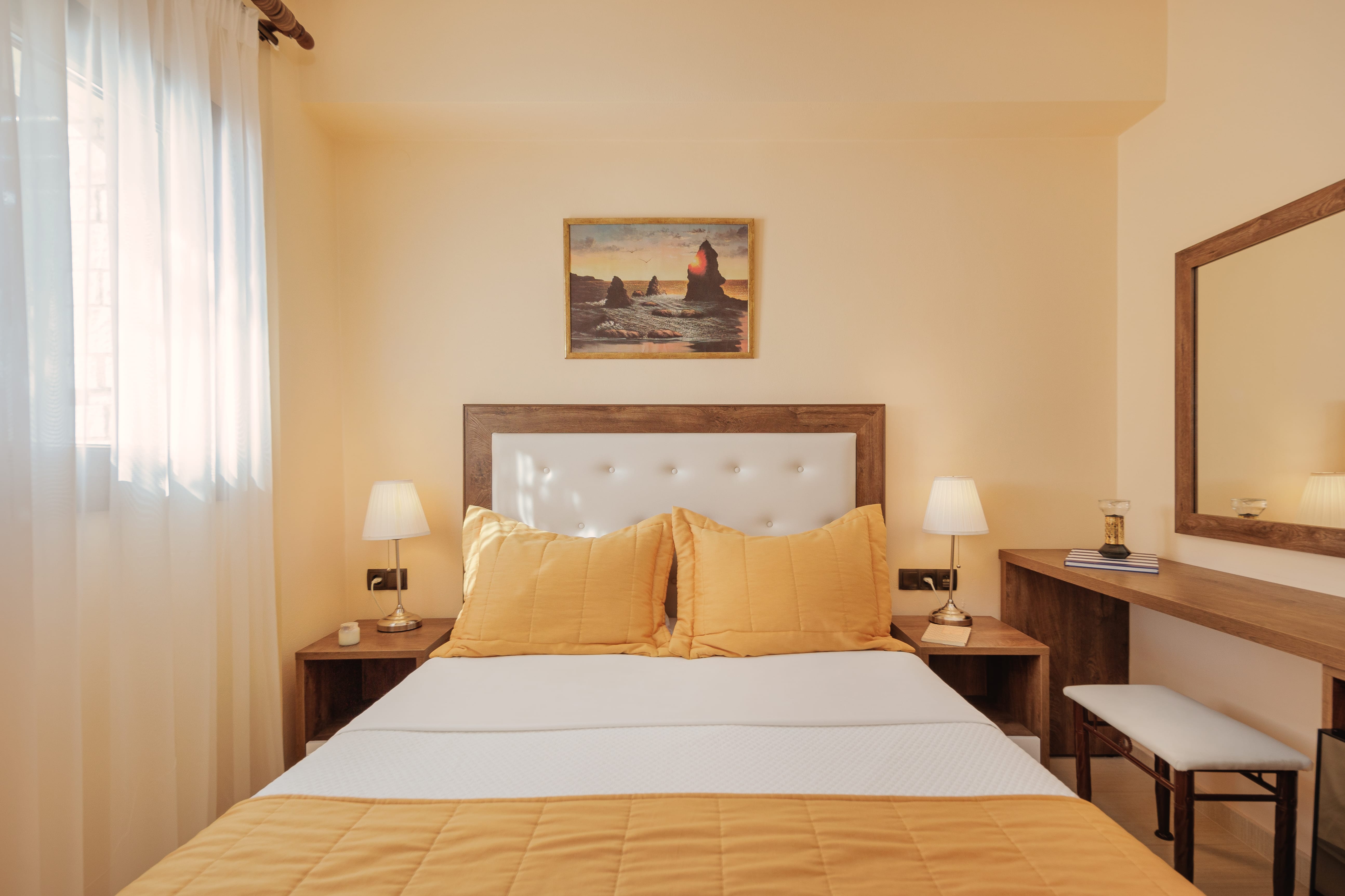 a hotel room with a bed and desk