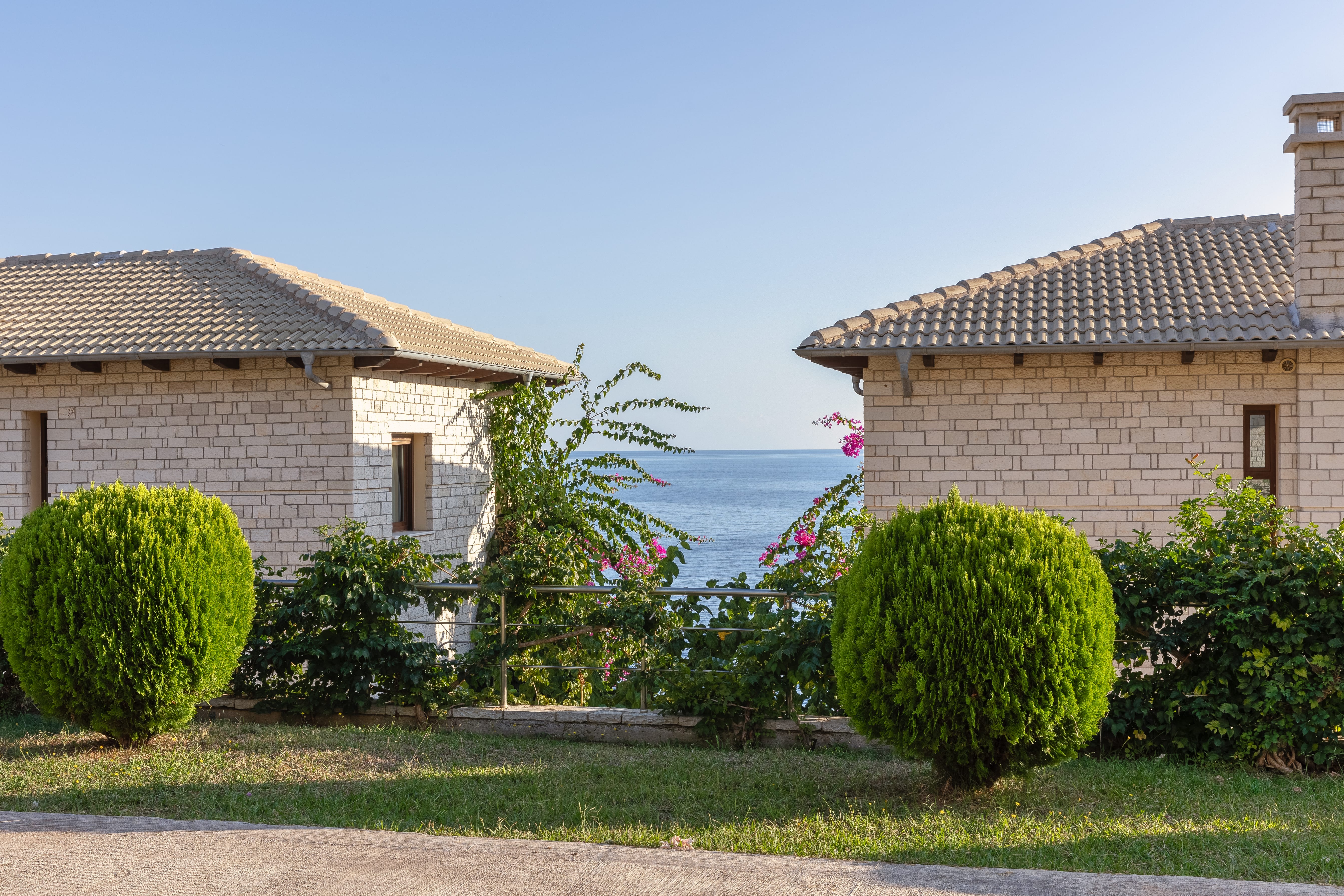 a house with bushes and trees