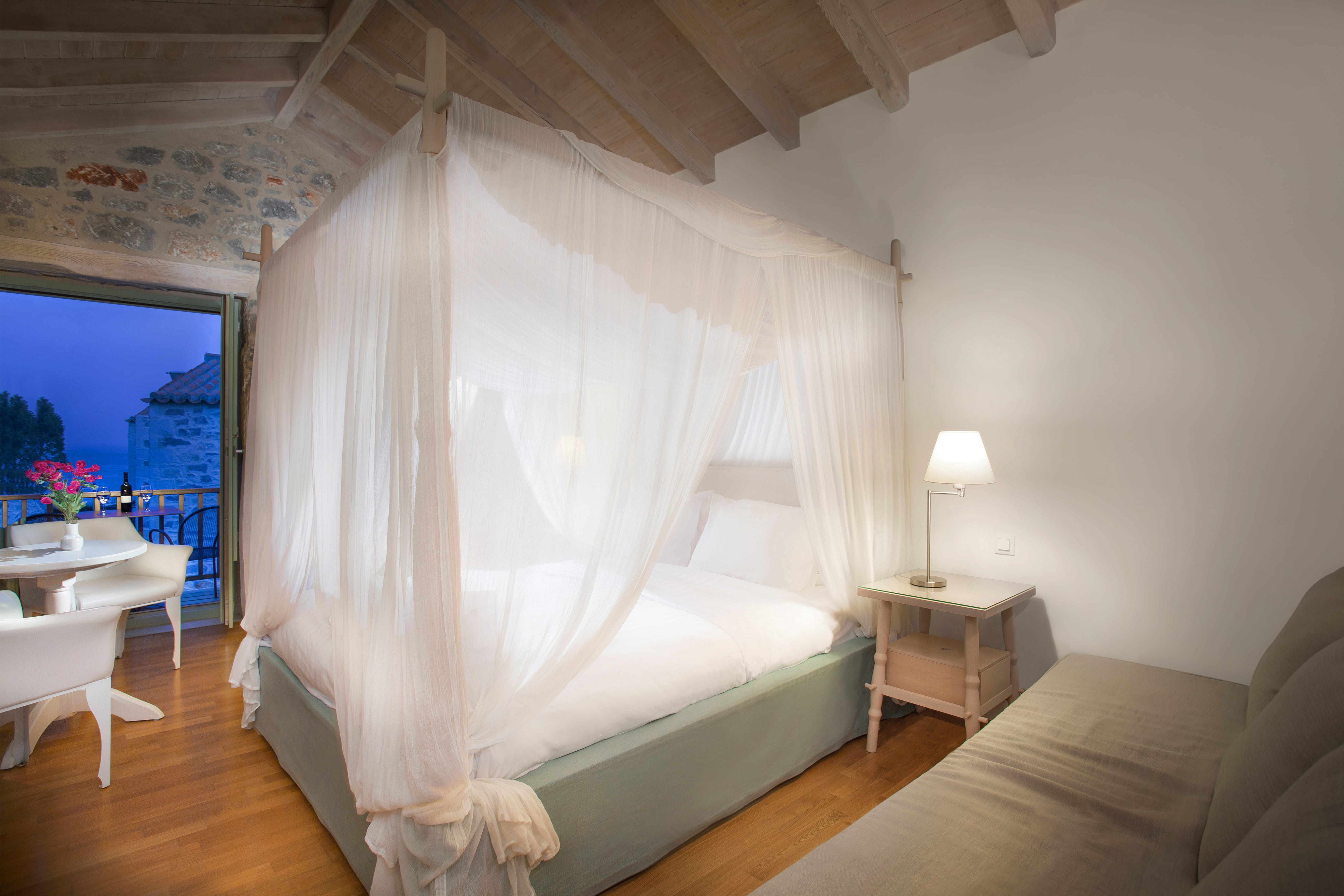 a bed with a white curtain