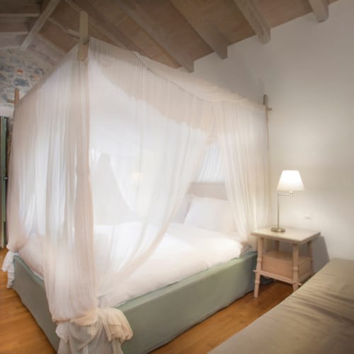 a bed with a white curtain