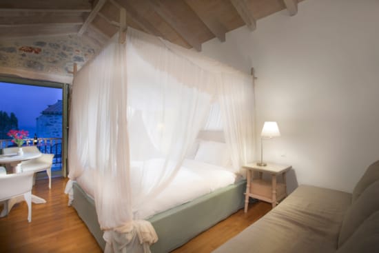 a bed with a white curtain