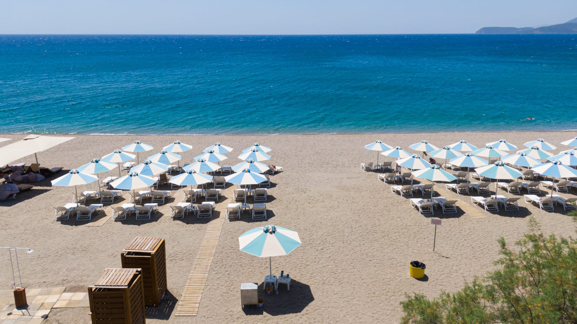 a beach with umbrellas and chairs