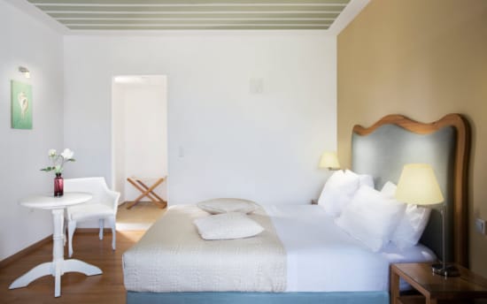 a bedroom with a bed and a table