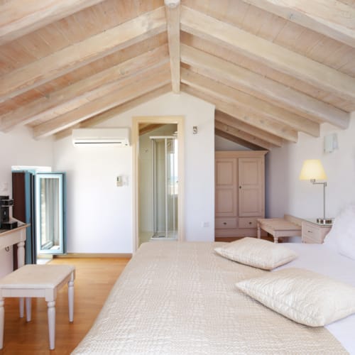 a bedroom with a bed desk and a television