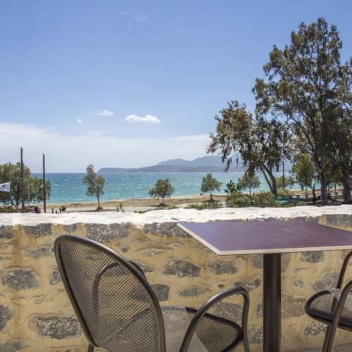 a table and chairs on a beach