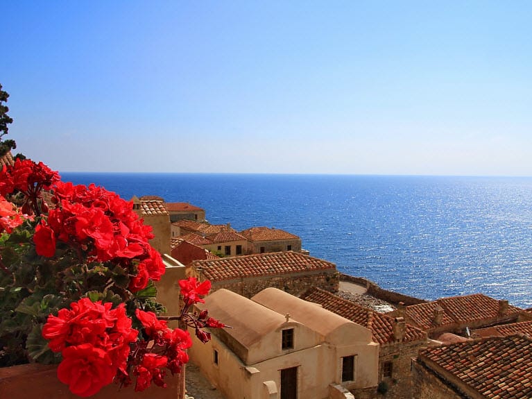 a group of buildings next to a body of water