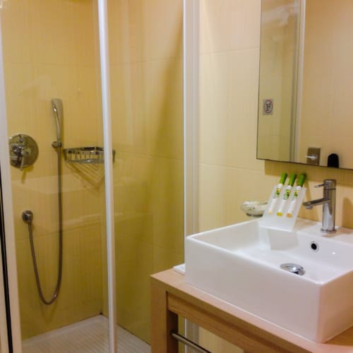 a bathroom with a shower unit and sink