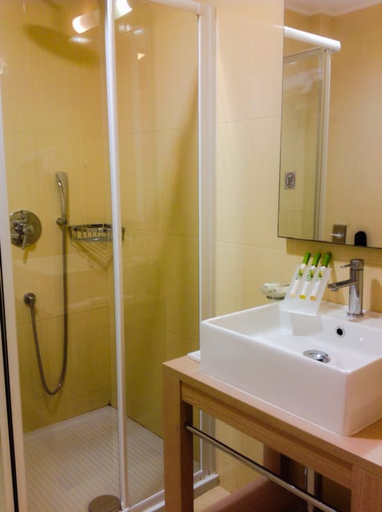 a bathroom with a shower unit and sink
