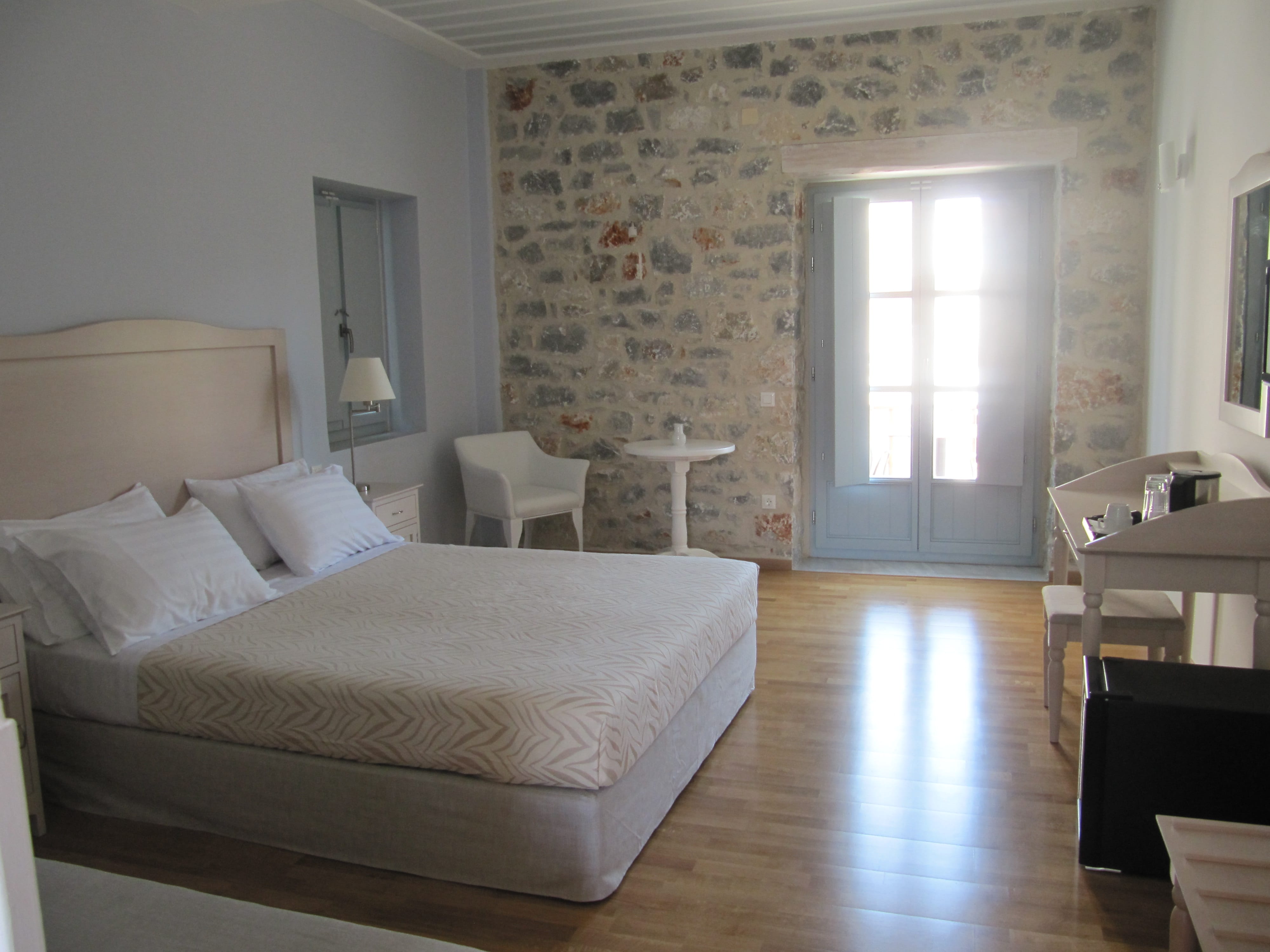 a bedroom with a bed and chairs