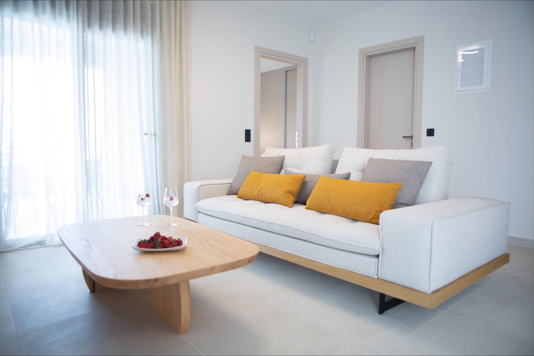 a white couch with yellow pillows