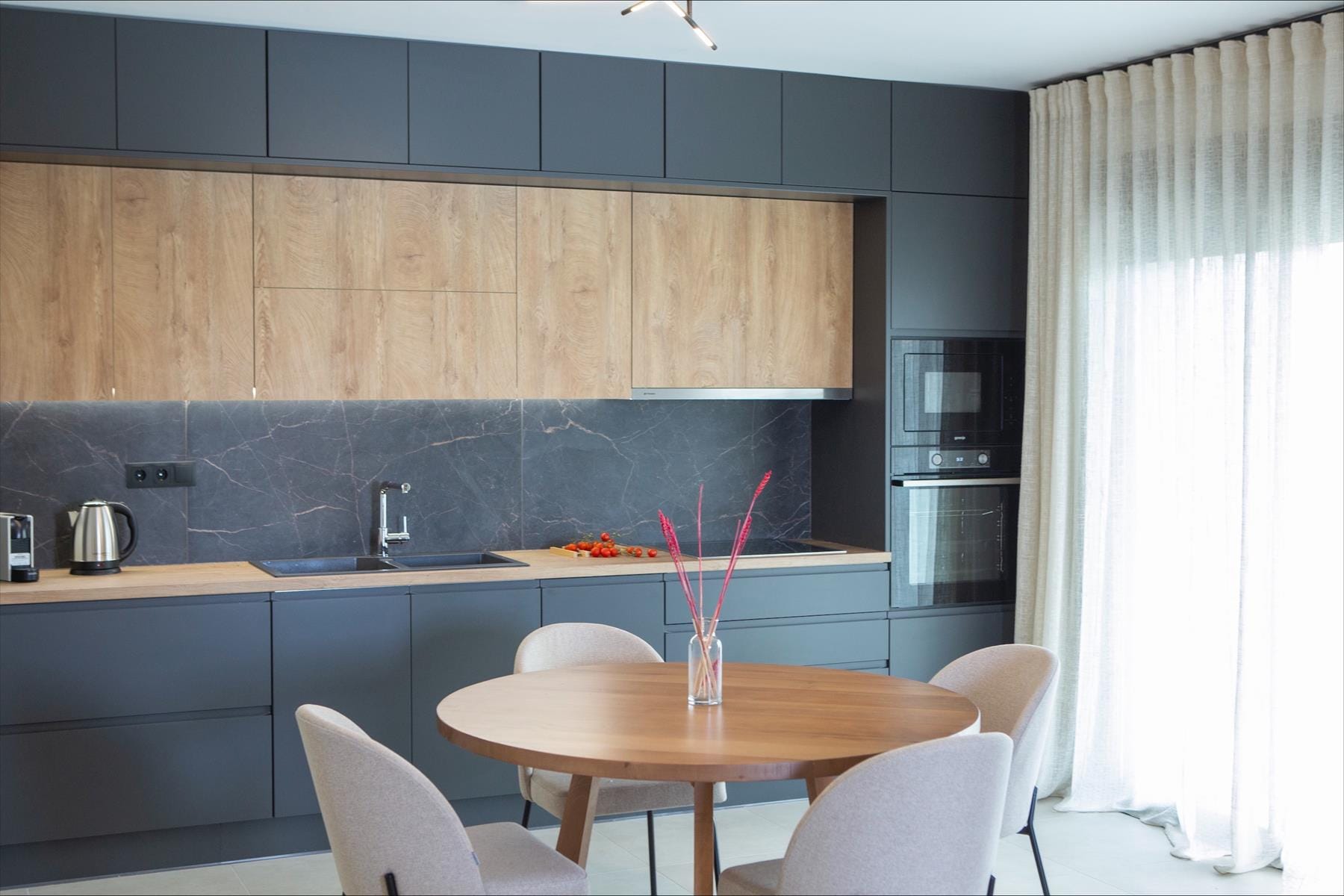 a kitchen with a table and chairs