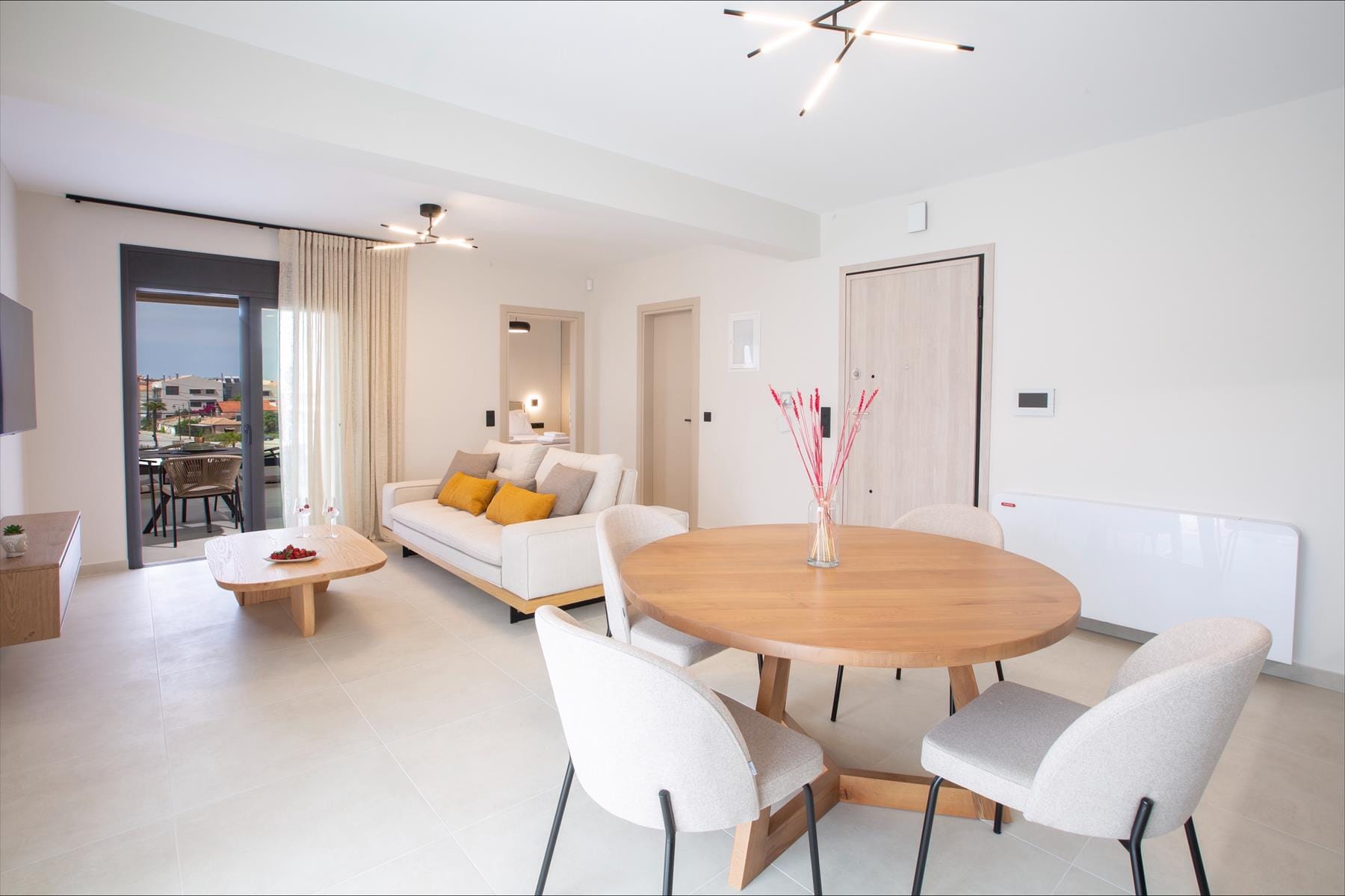 a living room with a table and chairs