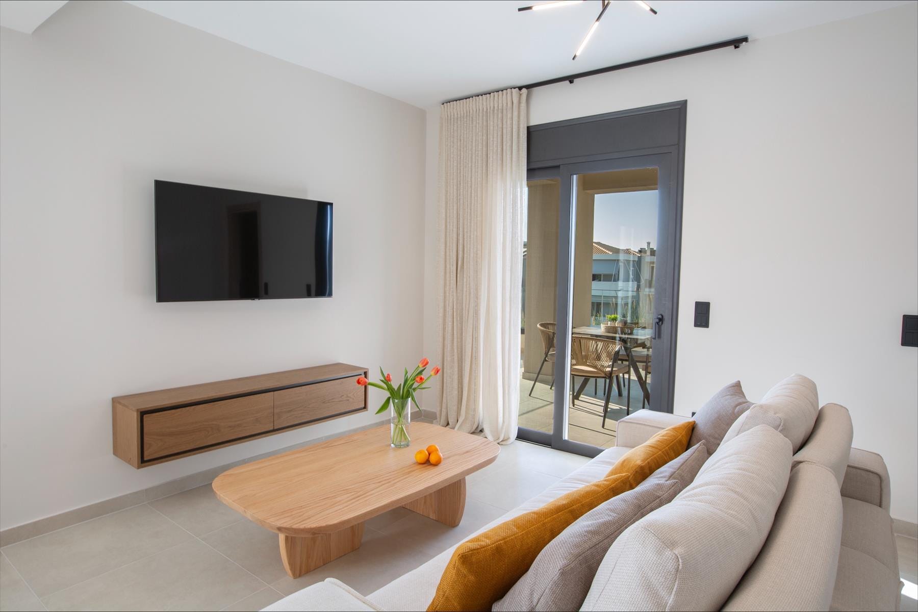 a living room with a tv and couches