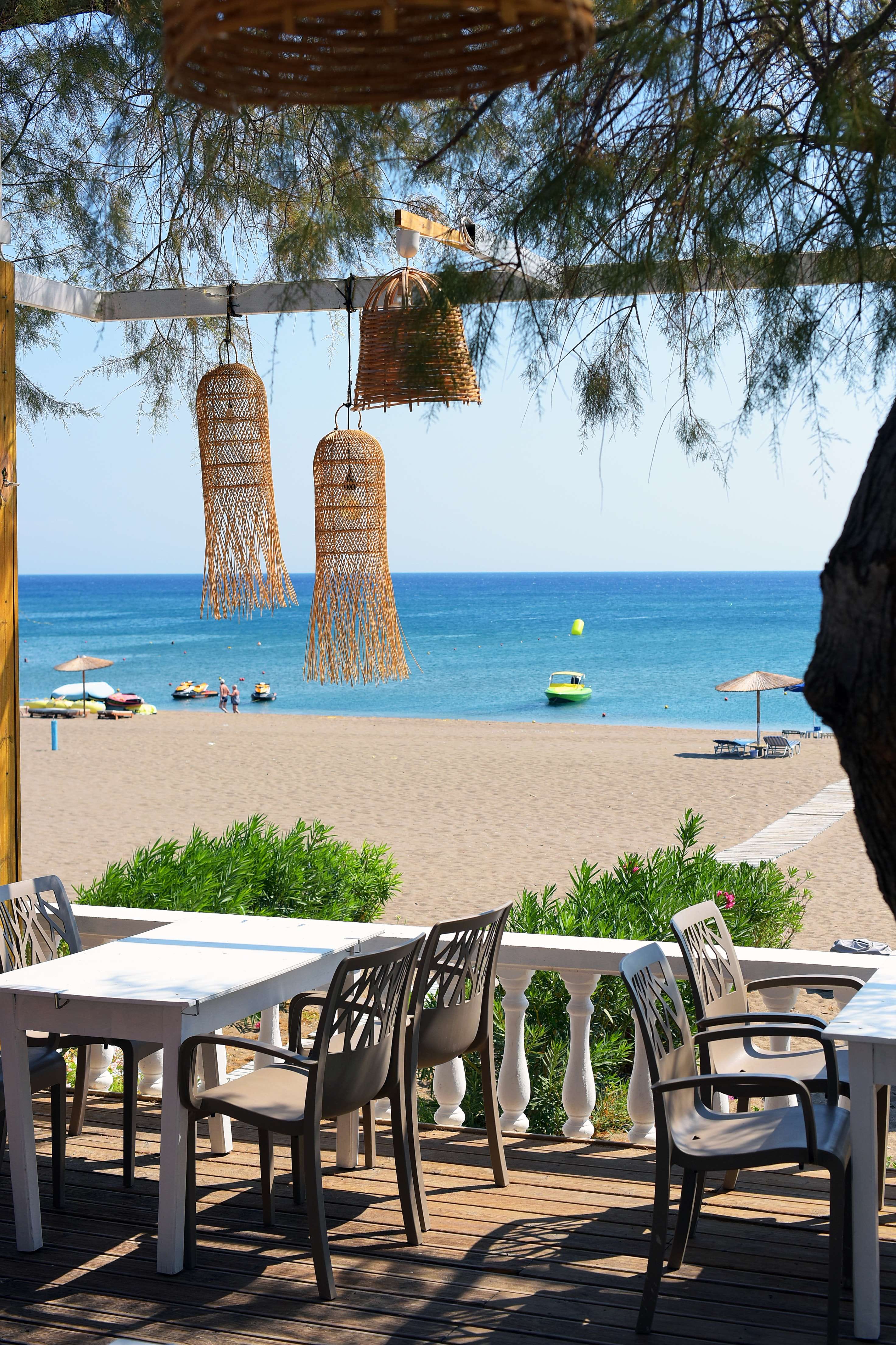 a beach with tables and chairs