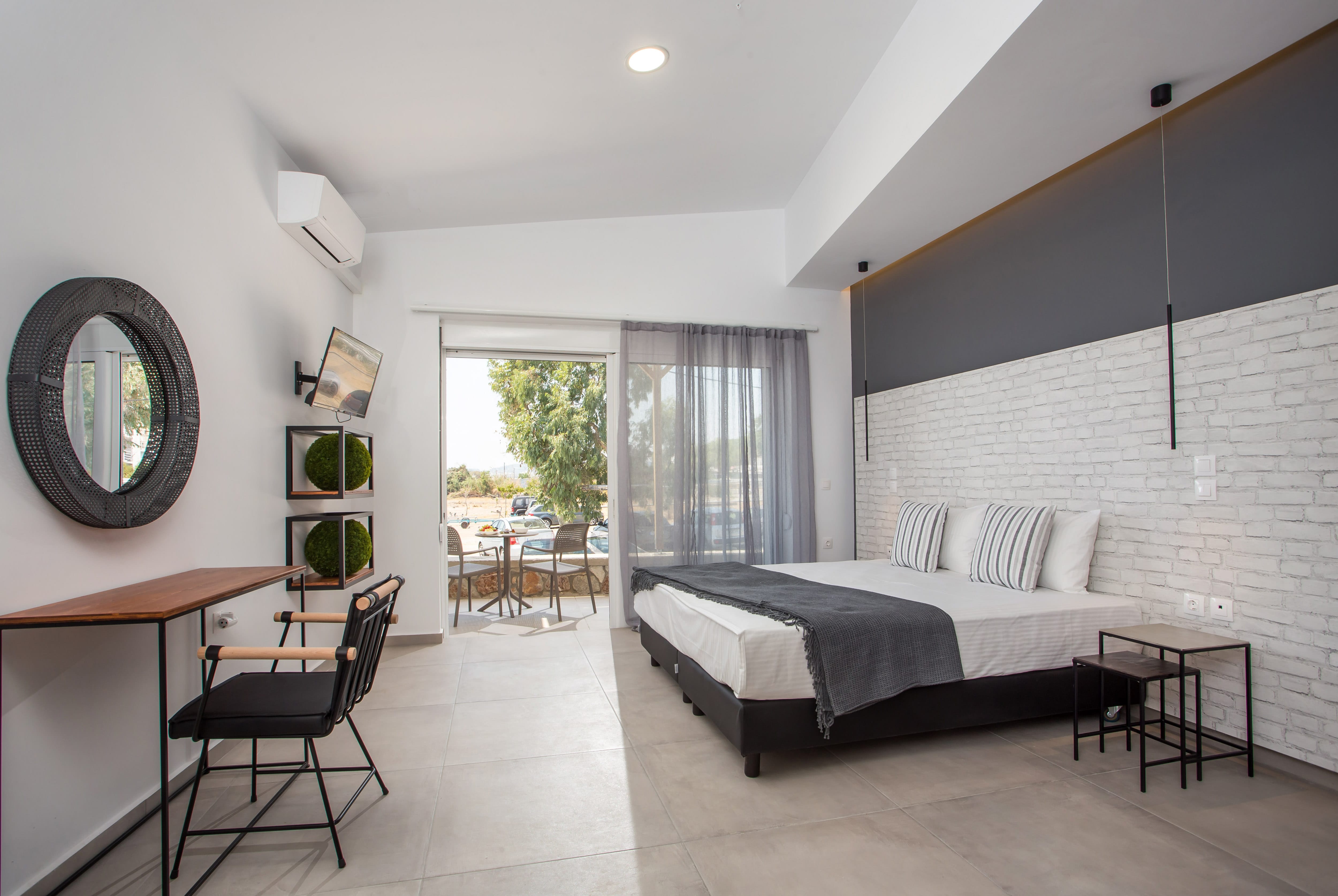 a bedroom with a bed and chairs