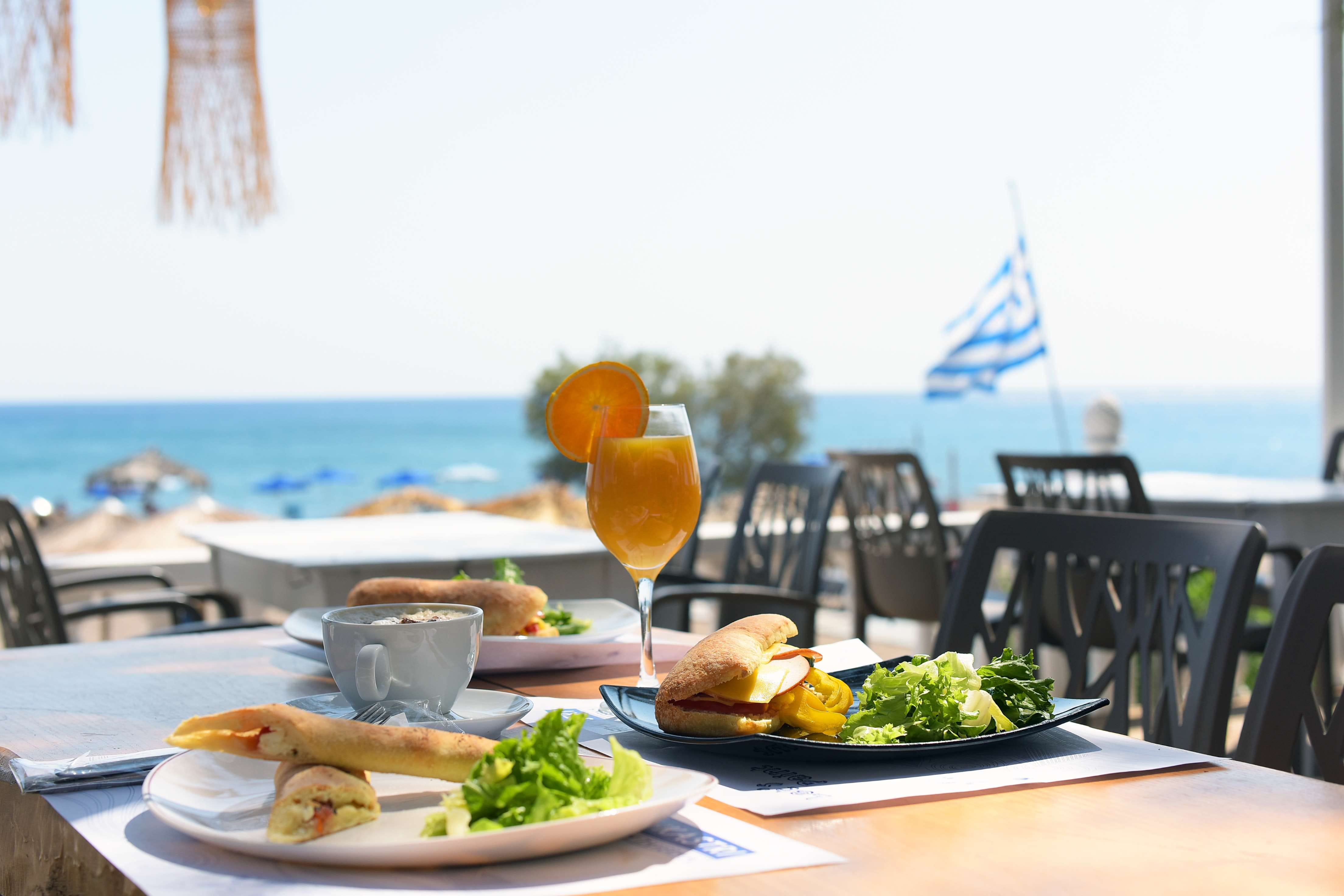 a table with food and drinks on it by a beach