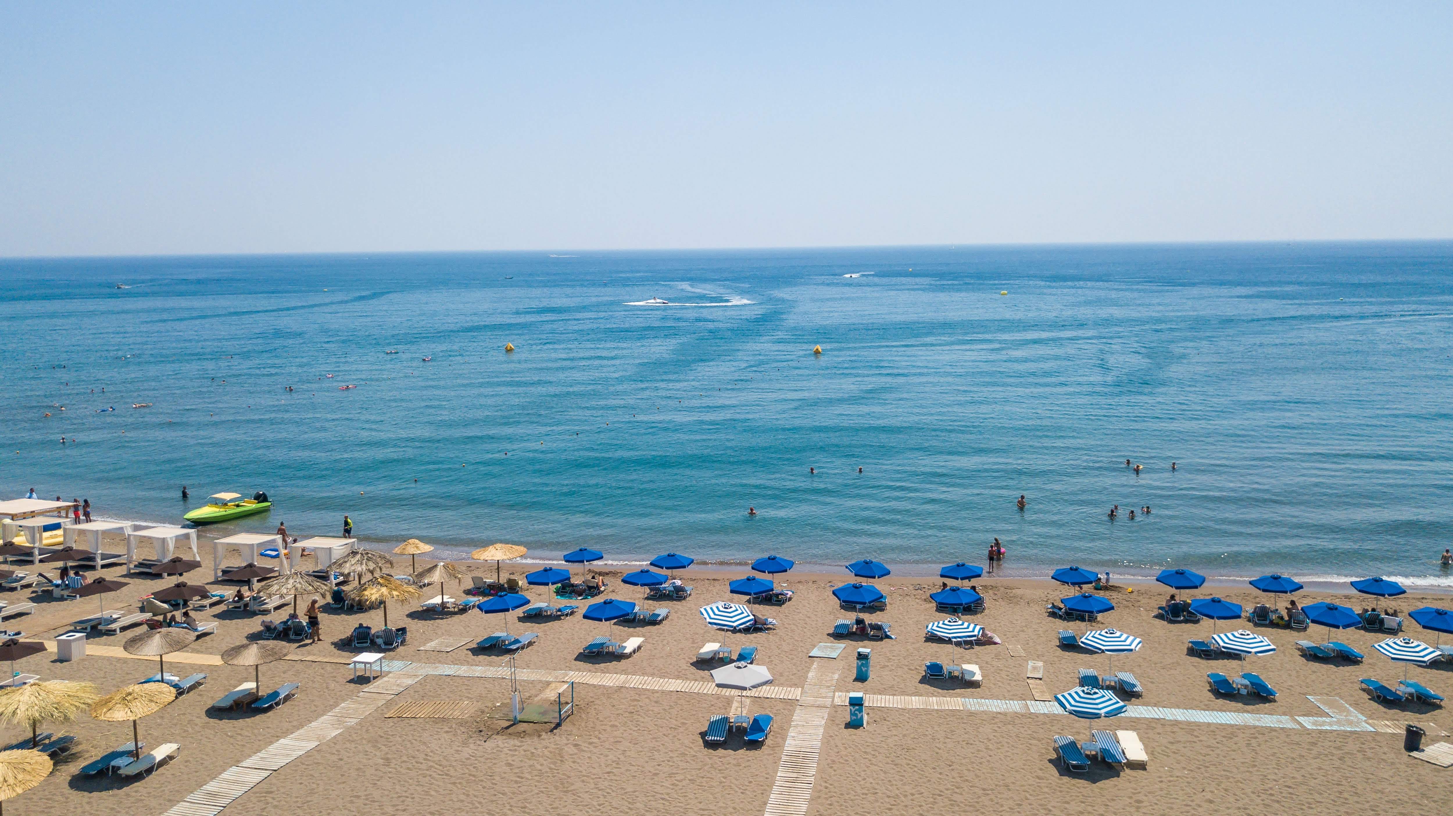 a beach with many cars parked on it